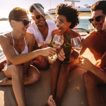 a group of people sitting and drinking wine